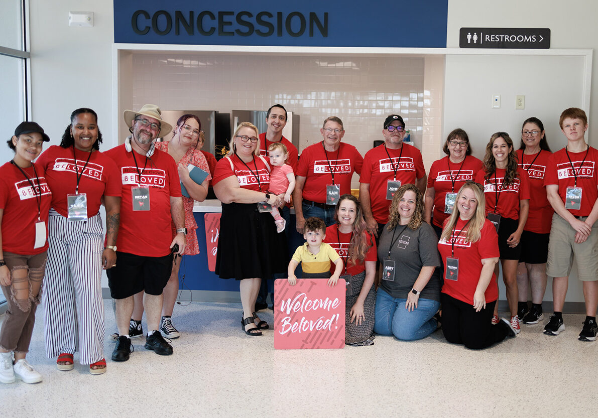 connect team poses for picture in red shirts